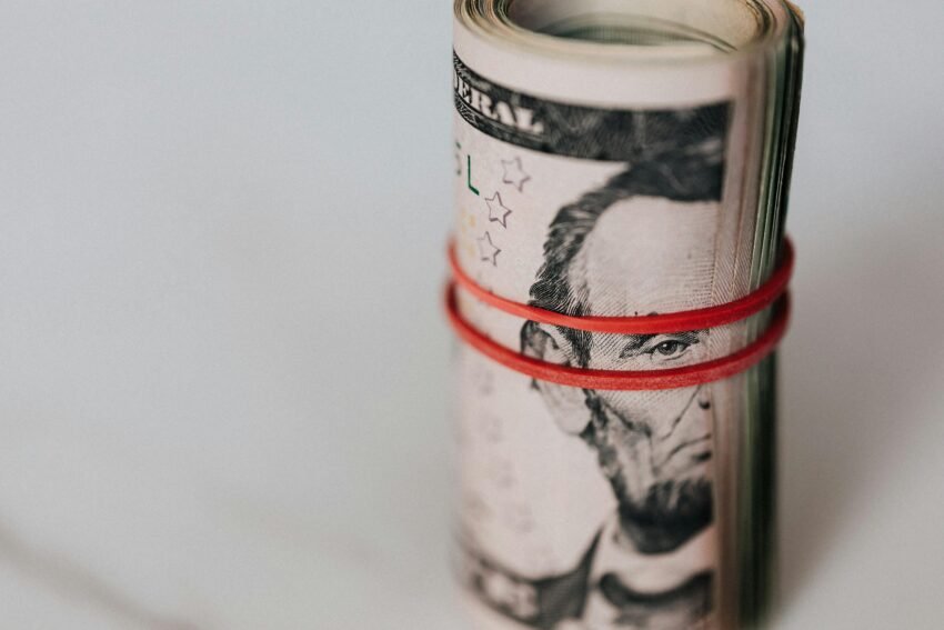 Roll of american dollars tightened with red band