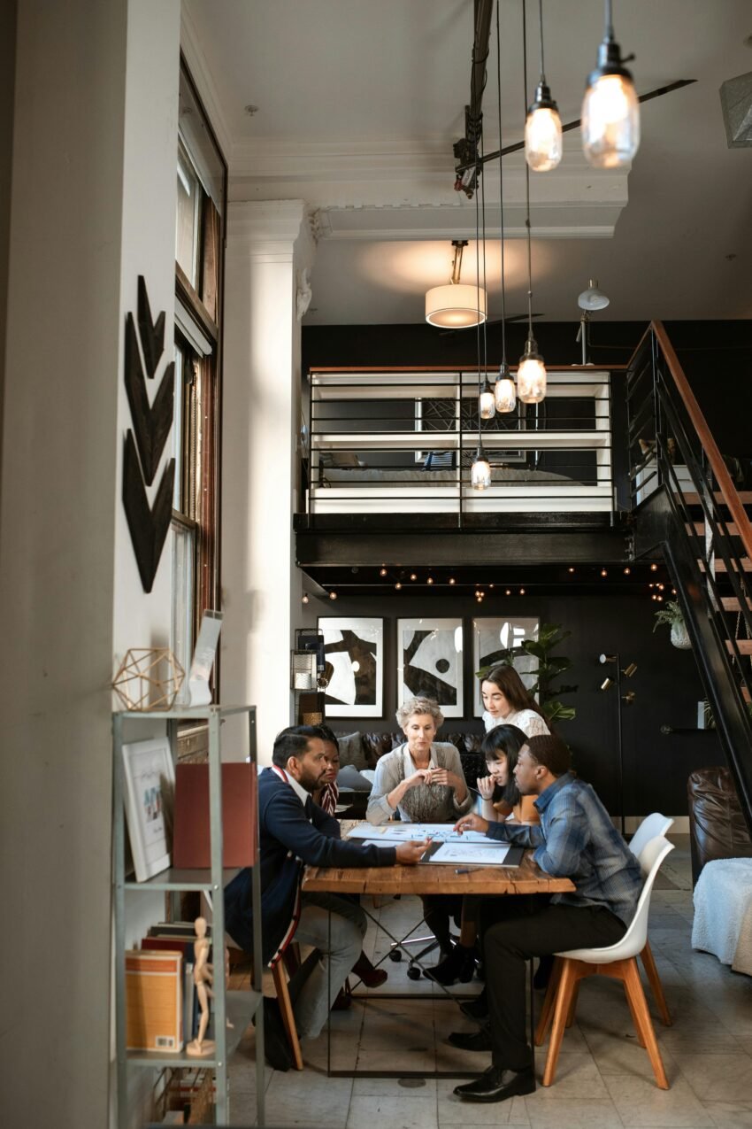 People Sitting on Chair Near White Wooden Shelf